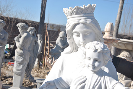 Religious marble Mary holds baby Jesus for church usage