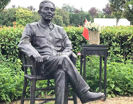 Cast bronze life size one man sits on a chair/stone